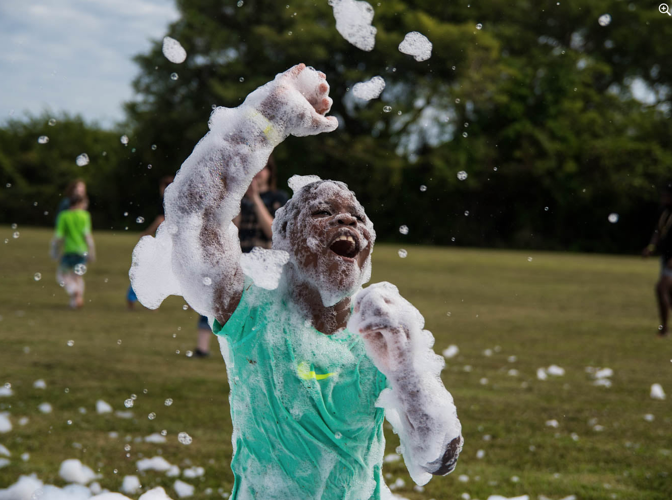 Boy playing in foam